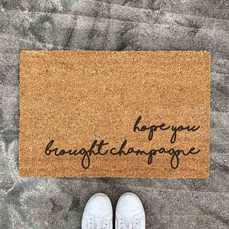 hope you brought champagne Door Mat